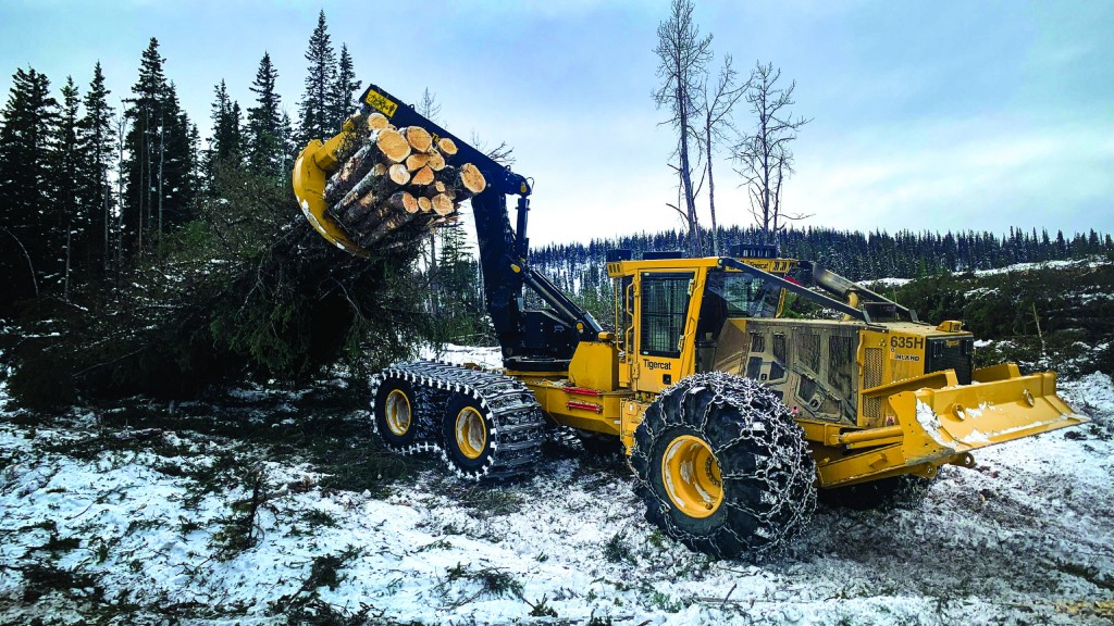 A skidder collects logs on a job site