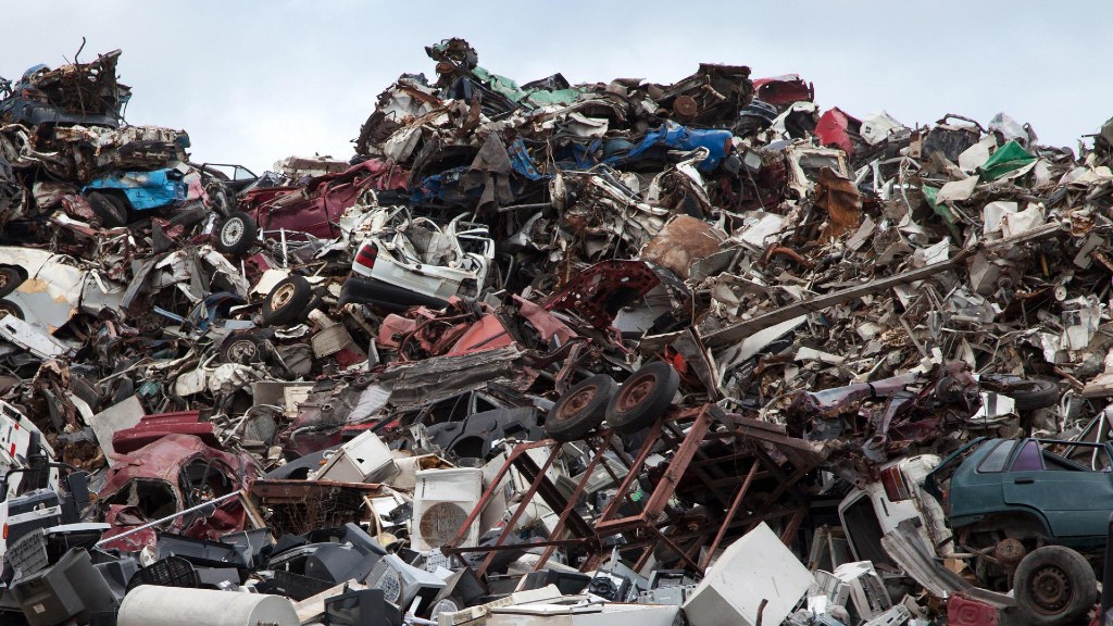 Metal scrap is piled up in a scrapyard