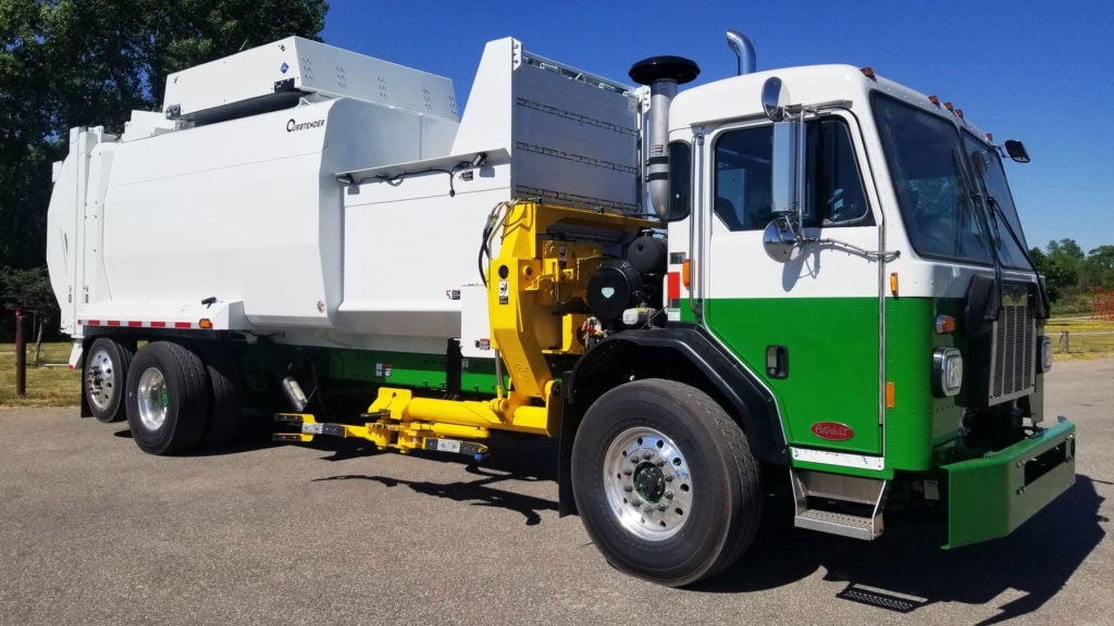 An automatic side loader collection truck is parked in a parking lot