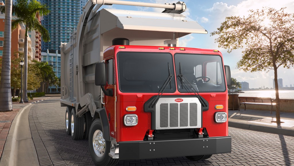 A collection vehicle is parked on a street