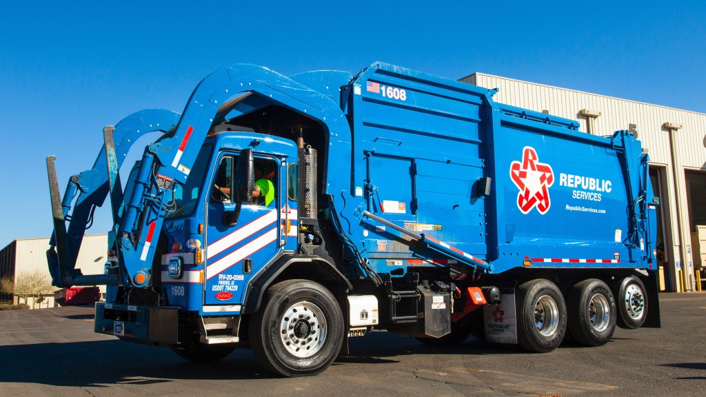 A collection truck pulling out from a facility