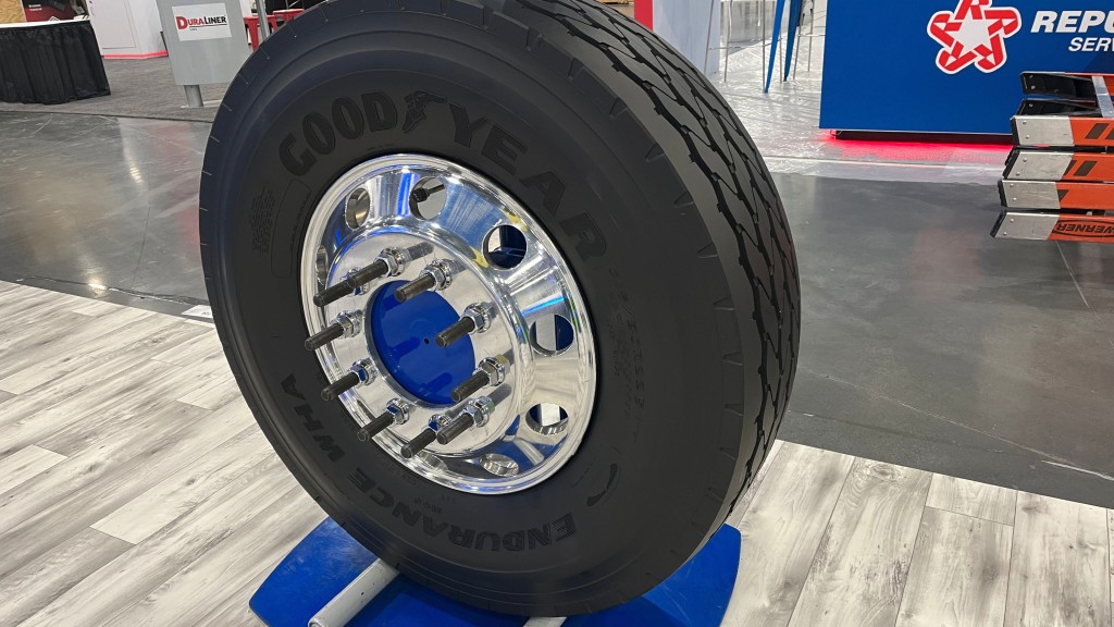 A tire sits on a display at a trade show