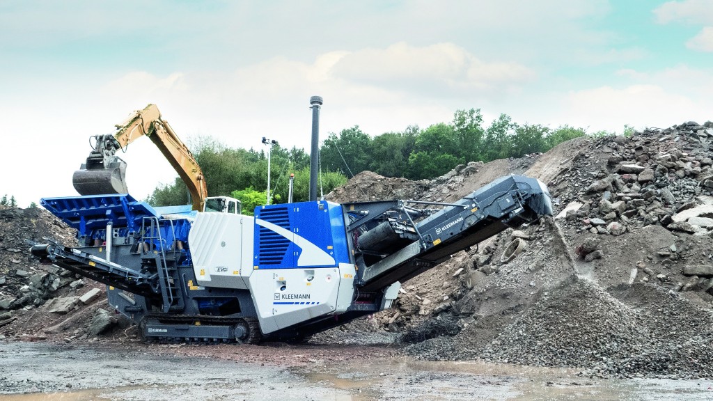 A mobile crusher crushes material on a job site