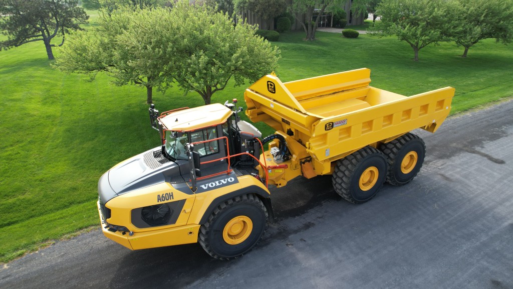 An articulated haul truck travels on a road