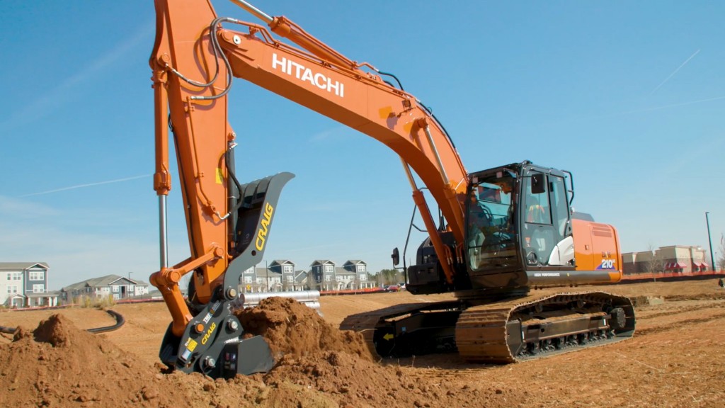 An excavator picks up dirt on a job site