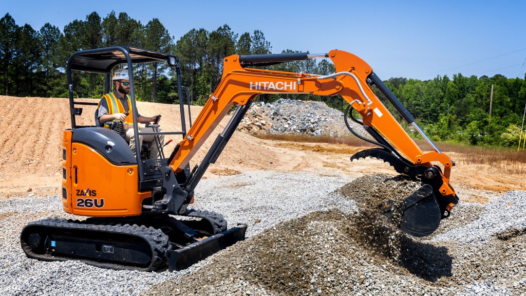 An excavator moves gravel on a job site