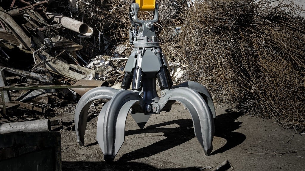 A grapple is placed in a scrap recycling yard