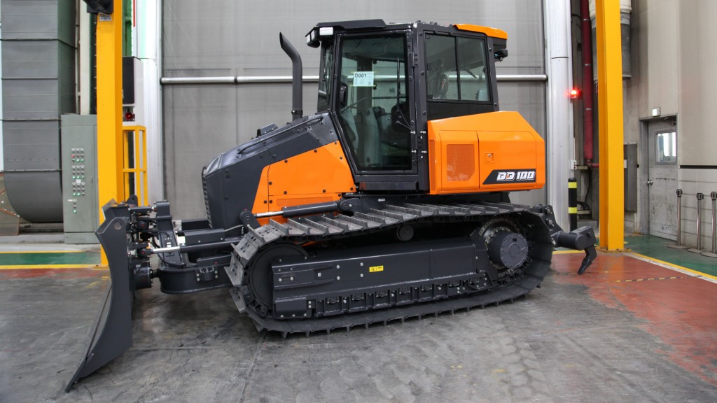 A dozer is parked inside a manufacturing facility