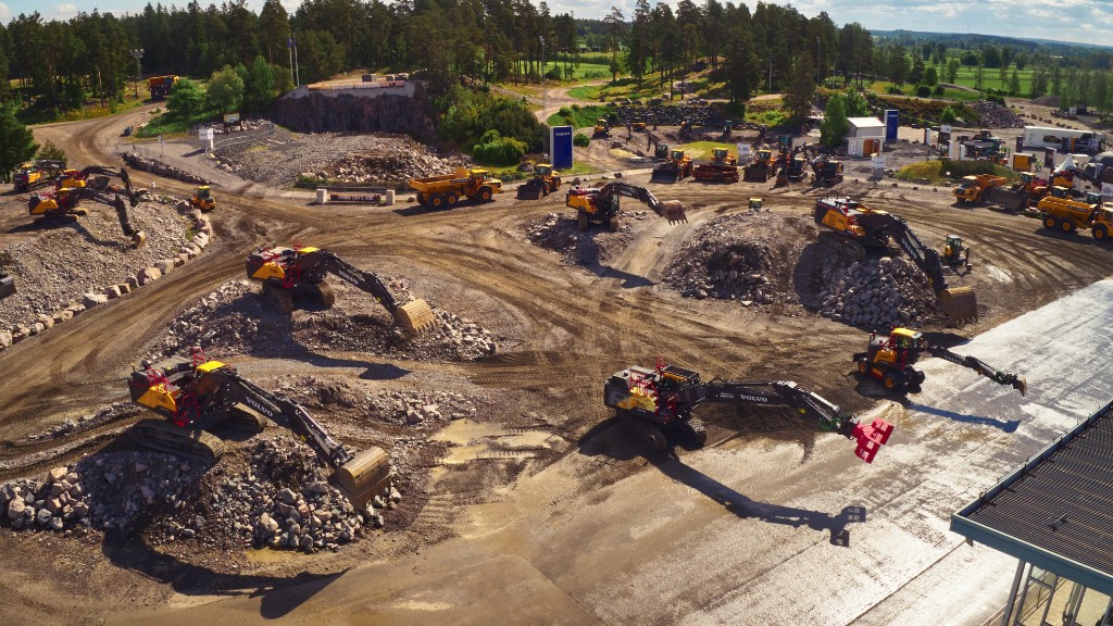 A fleet of excavators digs dirt on a job site