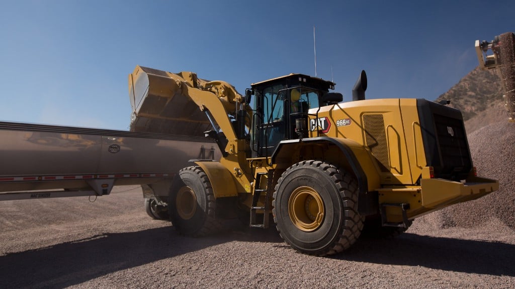 A wheel loader empties its bucket into a truck