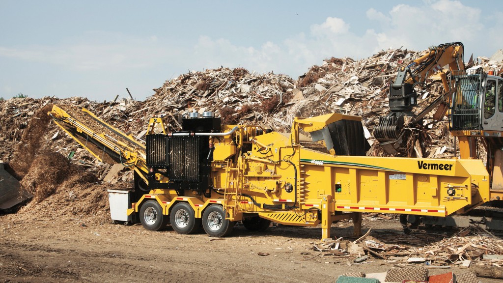 A horizontal grinder grinds material on a job site