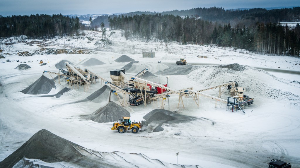 A crushing and screening plant operates in the snow