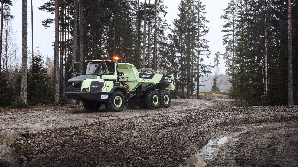 An articulated hauler travels down a gravel road