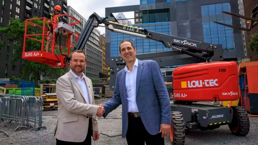 Two people shake hands on a job site