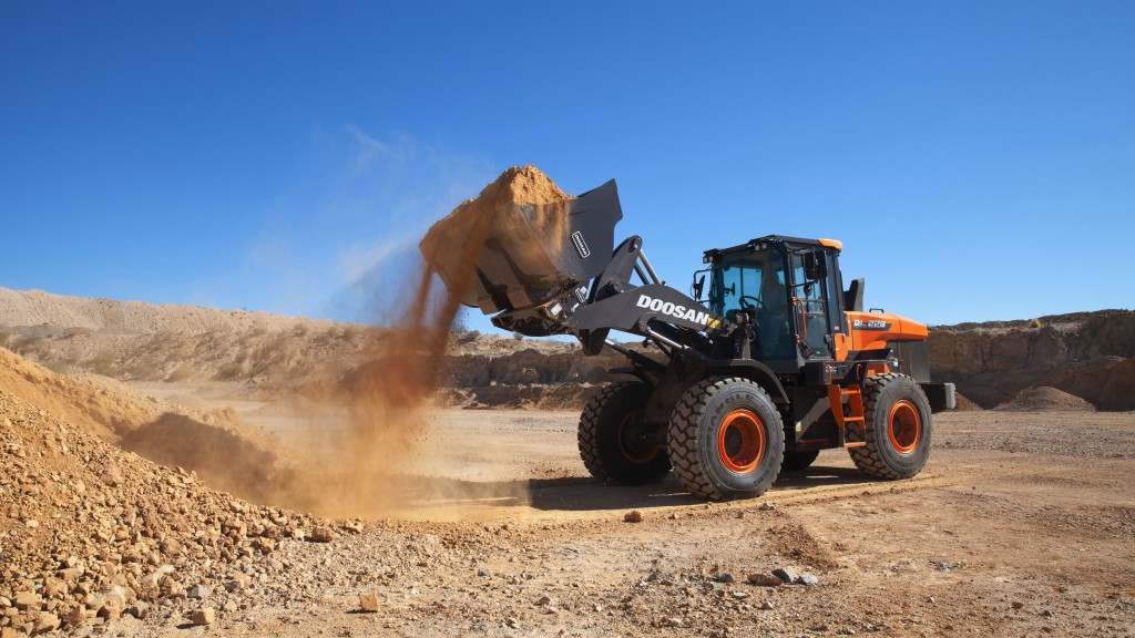 A wheel loader moves dirt on a job site