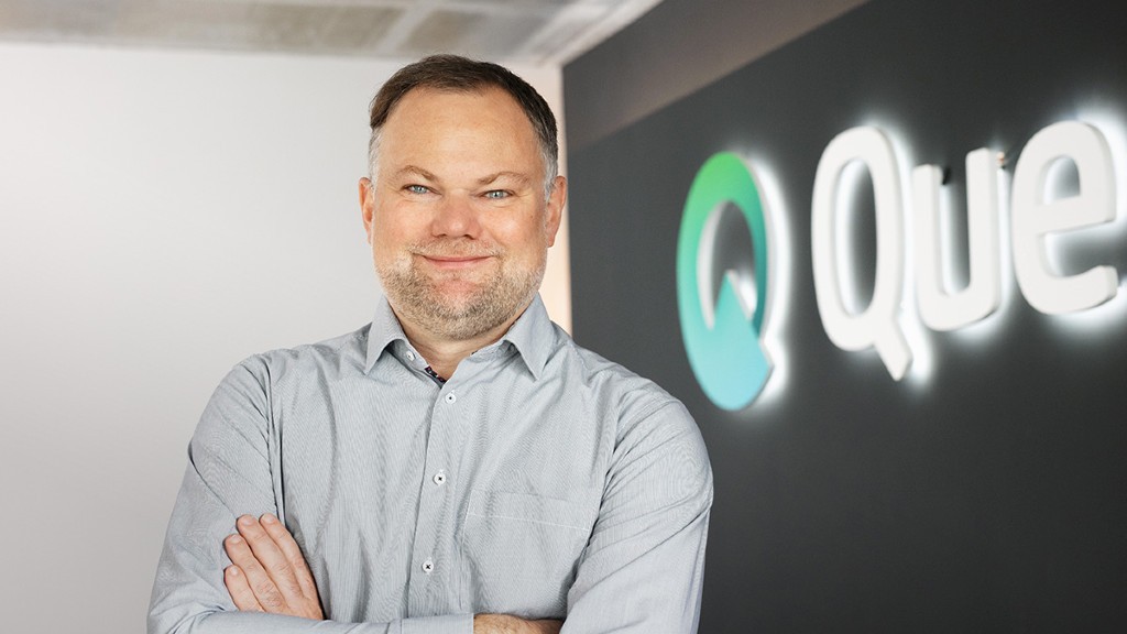 Markus Becker stands near a Quentic sign