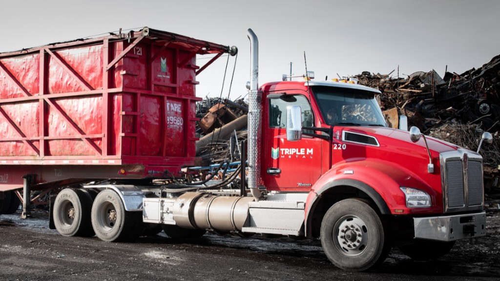 A truck drives through a metal recycling yard