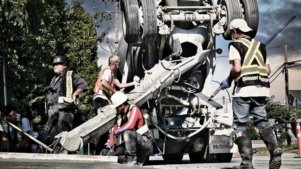 Workers pour concrete  out from a concrete truck