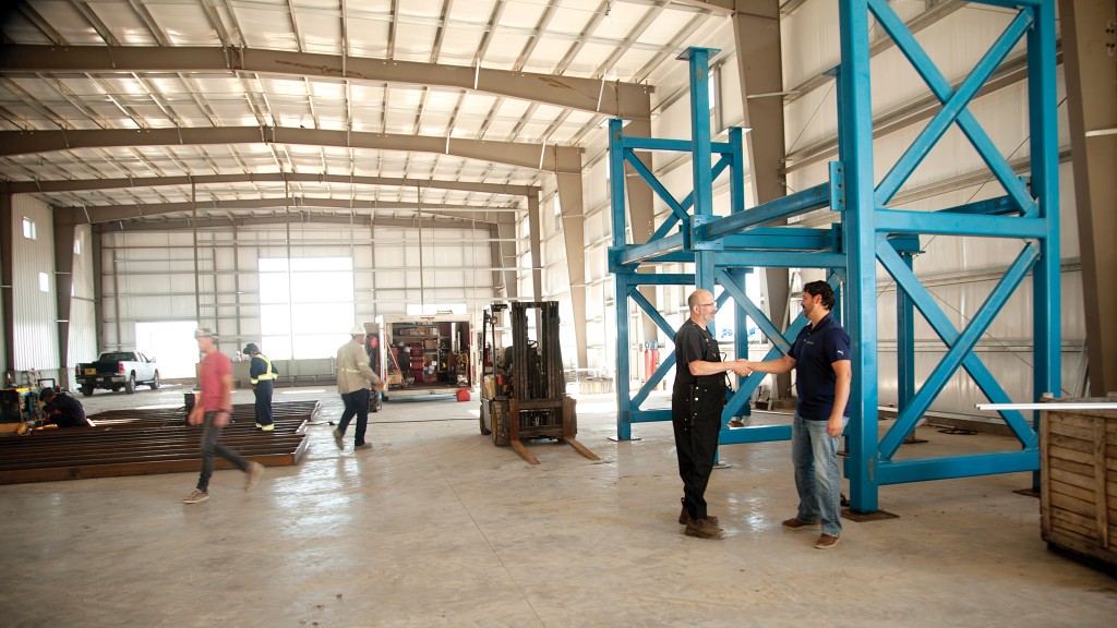 Workers mill around the inside of a facility