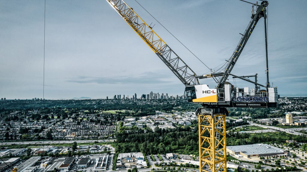 A tower crane parallel with a city skyline