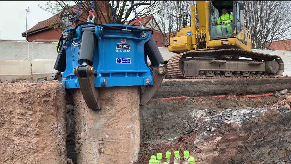 A pile cropper cuts a concrete pile on a job site