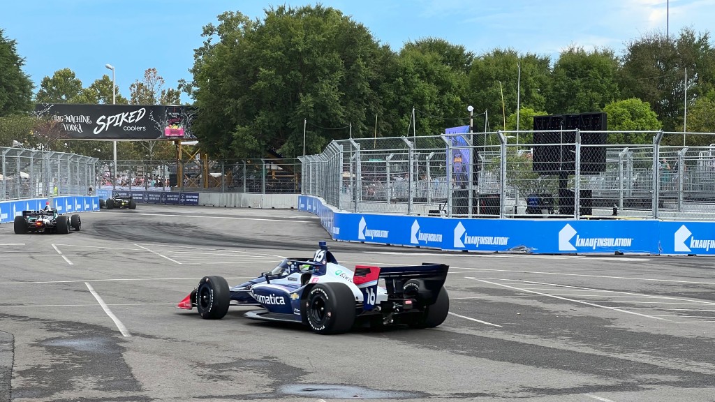 A car turns a corner in an IndyCar race