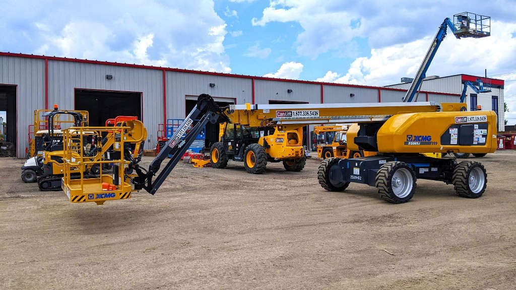 A telescopic boom lift parked in a yard