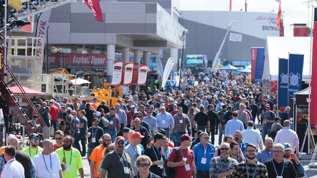 A large crowd of people at a trade show