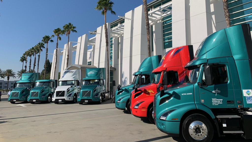 Electric trucks are parked in a parking lot