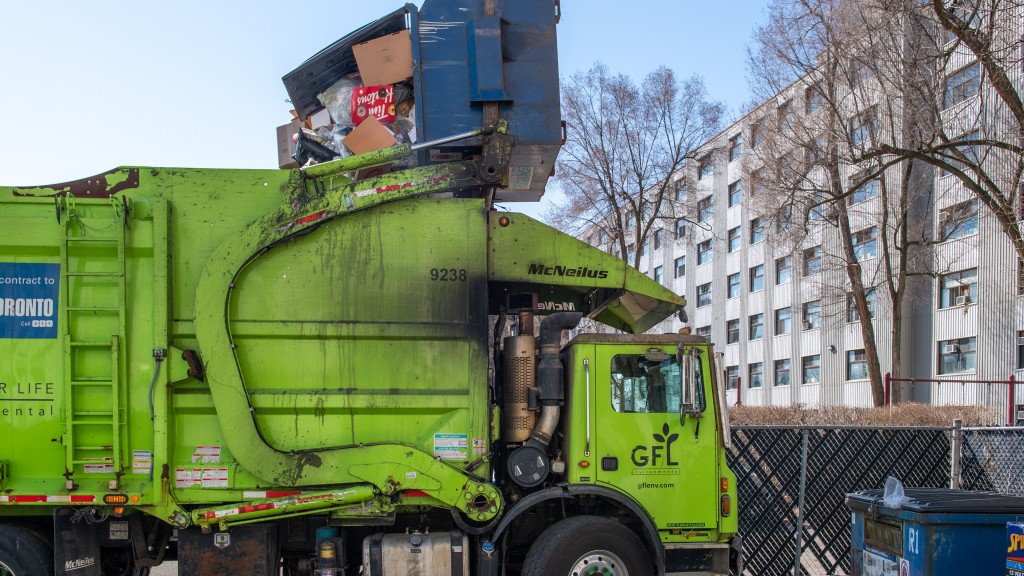 A collection truck dumps waste into its body