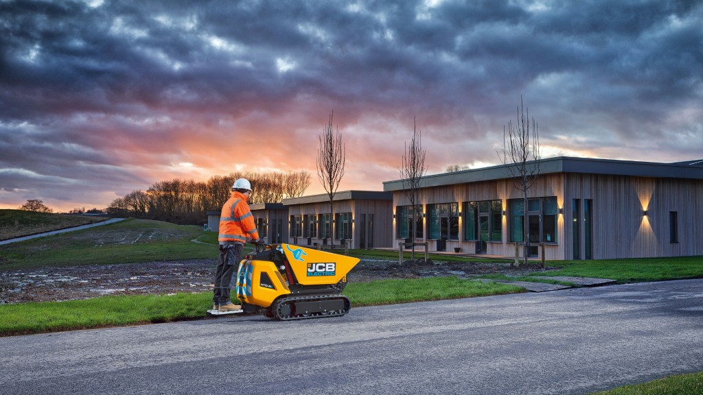 An operator rides an electric dumpster