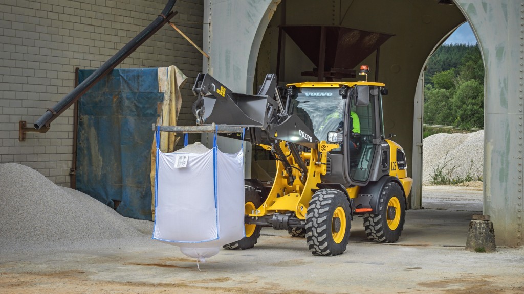 A compact wheel loader moves around on a job site