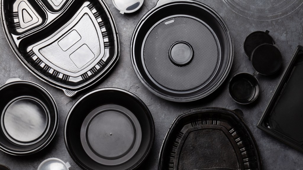 Black plastic containers are spread out on a table