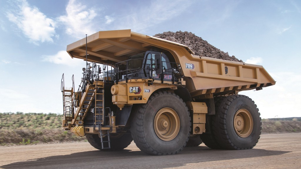 A mining truck with a load drives down a road