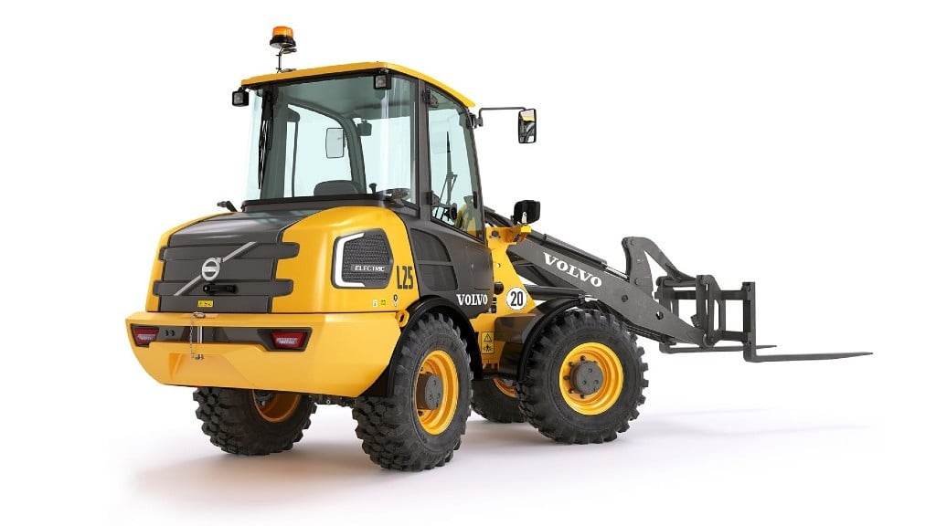 A compat wheel loader is parked on a white background