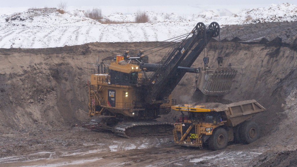 A mining shovel loads a truck on a job site