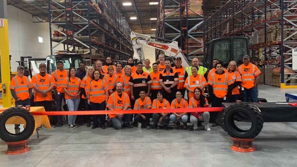 Bobcat employees pose for a photo in a distribution centre