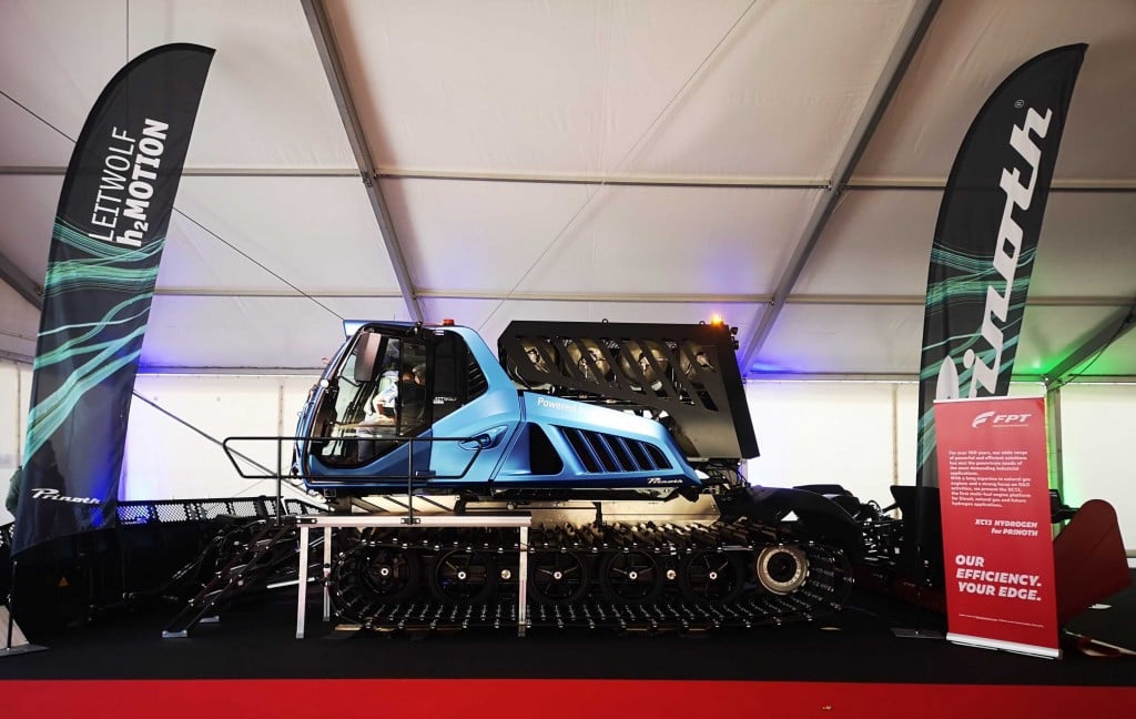 A snow groomer sits on a stage