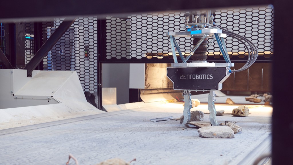 A robotic picker picks C&D waste on a conveyor