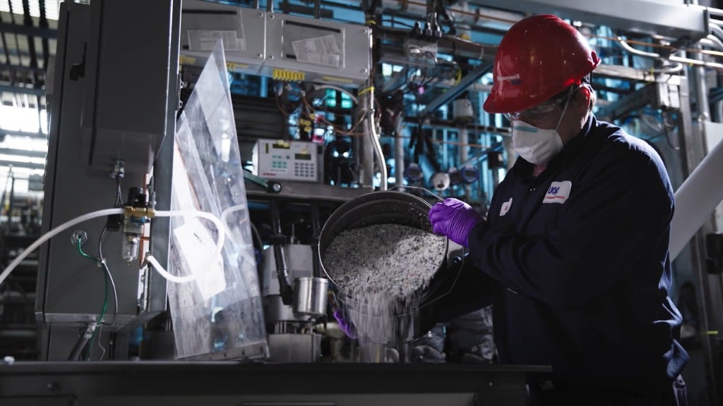 Somebody pours plastic pellets out of a bucket