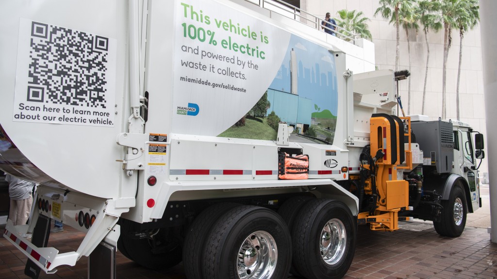 An electric collection vehicle is parked on a street