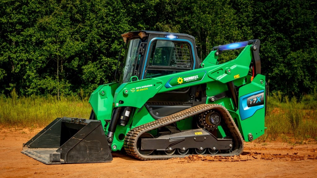 A compact track loader is parked on a job site