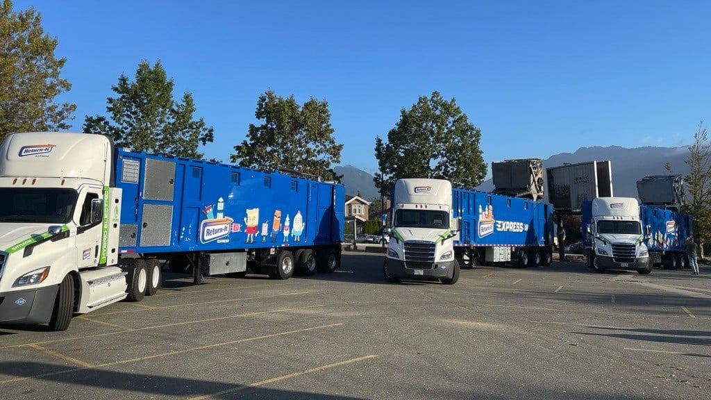 Three transportation trucks sit in a parking lot