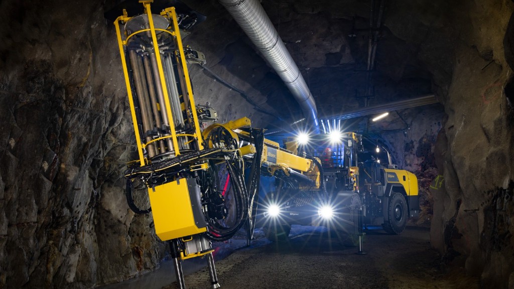 A drill rig drives down a tunnel