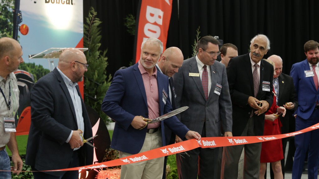 A group of people cut a ribbon