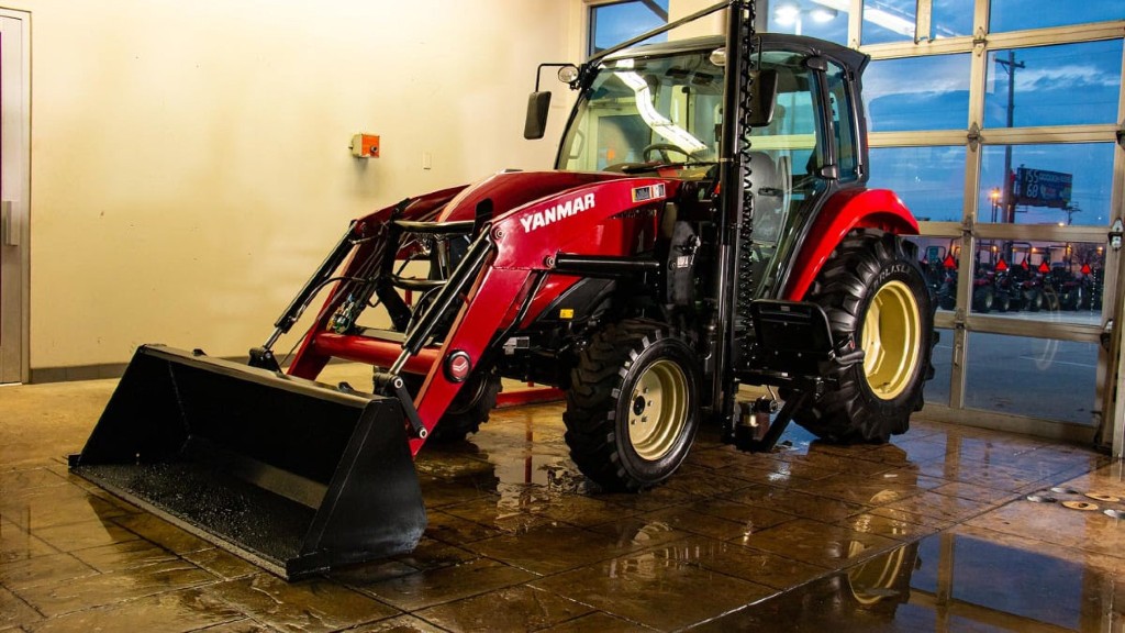 A tractor is parked inside of a building