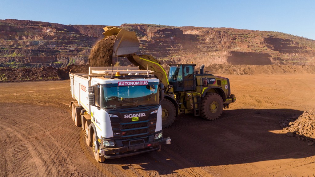 A wheel loader dumps a load into a truck