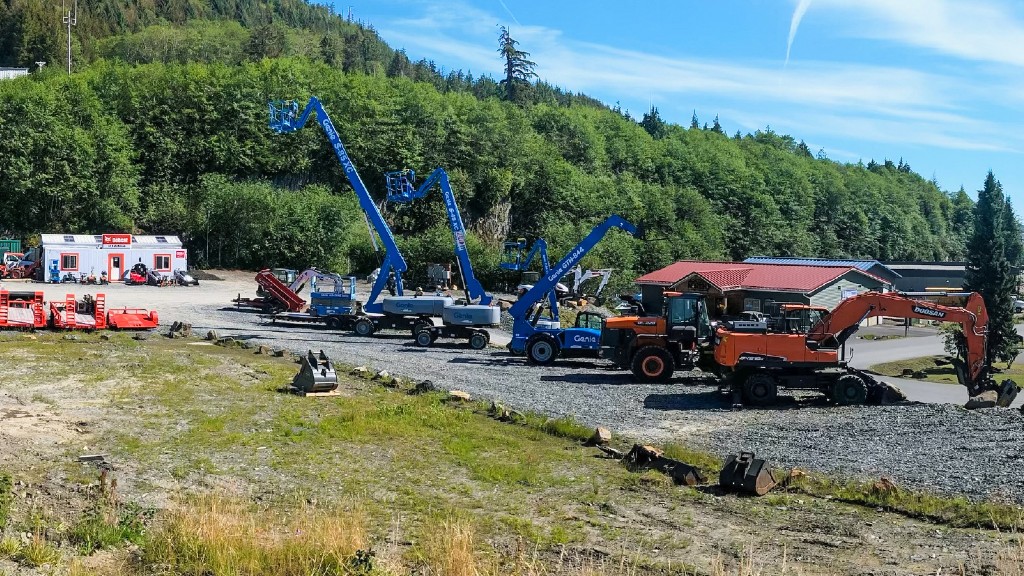 Heavy equipment is parked on a gravel parking lot