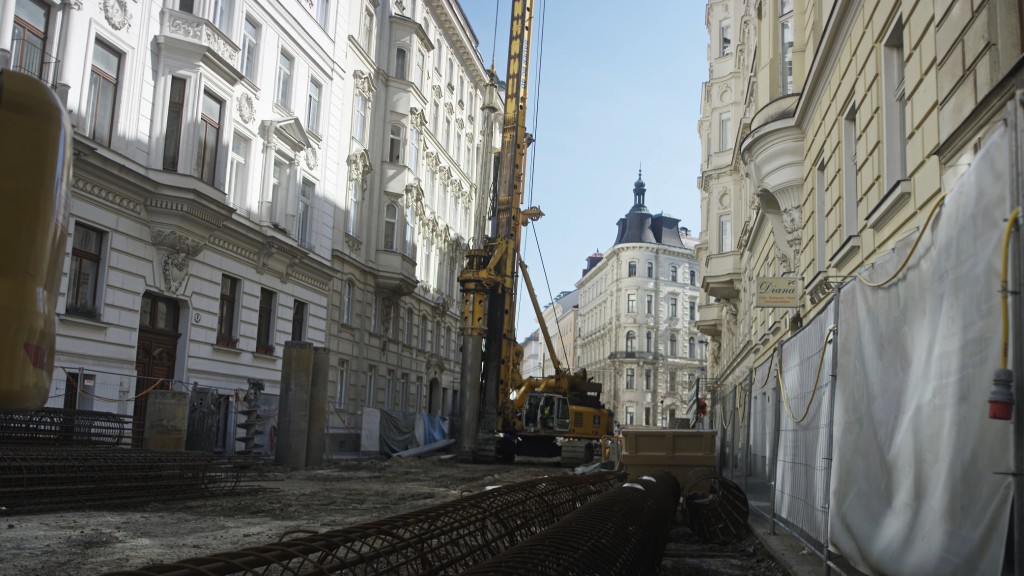 A drill rig operates on a construction site in a street