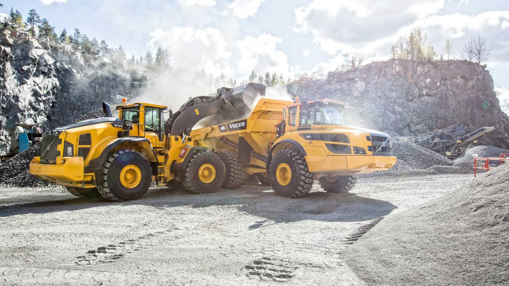 A wheel loader dumps material into a truck